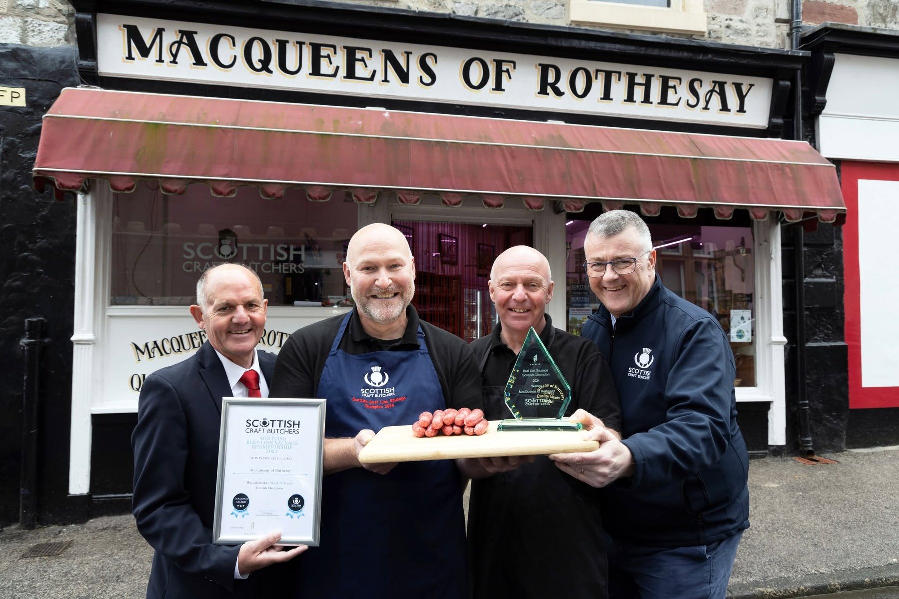 Macqueens team outside the Rothesay shop with their steak link award